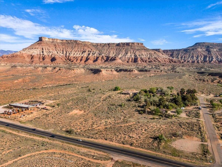 Check out this new development opportunity! 6.98 acres of prime commercial land in Virgin, Utah. This amazing location and expansive property are the perfect setup for a mixed used commercial or residential development less than 20 minutes from nearby Zion National Park.

Located on the north side of Highway 9 the setting offers maximum opportunity with sweeping views of the surrounding mesas like Gooseberry and Smith's Mesa.  Additionally the new Sheep's Bridge bypass route coming in 2026 will add a great new dynamic of visitation to this wonderful gateway community.

Zoning currently allows for retail, restaurants, cafes, outfitters, higher density housing, and more.  Hotels and short term rentals are not permitted in this zone.