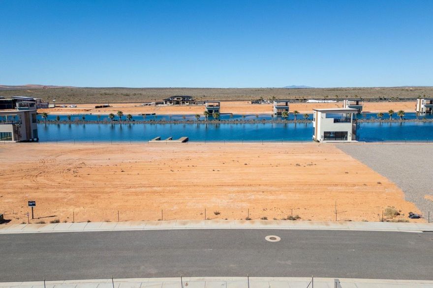 Experience a truly rare opportunity at Southern Shores, Southern Utah's premier private watersports community. Designed for those who value privacy, adventure, and a one-of-a-kind desert lifestyle, Southern Shores features three exclusive lakes: a half-mile boat lake, a professional cable wake park, and a surf lake anchored by the largest UNIT Surf Wave in the United States. This river-style standing wave is designed for all skill levels making it easy for beginners to ride on day one while still delivering endless fun for experienced surfers. The wave is equipped with lighting, sound, and a dedicated lounge area, creating an unforgettable setting for gathering with friends and family day or night.  The boat lake was thoughtfully engineered for performance, with shorelines designed to dissipate wakes and maintain consistently calm water. A central island divides the lake into two lanes, allowing simultaneous use by multiple boats while minimizing interference. Slalom buoy courses run along both sides and can be lowered below the waterline when wake surfing. The cable lake offers a full professional-grade wakeboard system complete with ramps, rails, and jumps.  This lake lot includes a private dock designed to accommodate two future boat lifts, with the option to build a custom boathouse at any time. Owners enjoy exclusive use of all three lakes along with community amenities including lighted tennis and pickleball courts, a communal marina dock, and on-site fuel for convenient refueling.  Southern Shores maintains a highly private ownership structure with no nightly rentals permitted, preserving the peaceful and exclusive environment for residents and their families. Conveniently located approximately 20 miles from St. George Regional Airport and just minutes from the Hurricane and Grassy Meadows airstrips, the community also sits near Copper Rock Golf Course.  Beyond the lakes, adventure surrounds you. Explore thousands of acres of public land and the Red Cliffs Desert Reserve, along with nearby Sand Hollow Reservoir and Quail Creek Reservoir for boating and recreation. World-class mountain biking, hiking, ATV/UTV trails, and desert exploration begin just minutes away. Southern Shores is also ideally positioned for day trips to some of the West's most iconic landscapes, including Zion National Park, Bryce Canyon National Park, the North Rim of the Grand Canyon, and Dixie National Forest.  This is more than a homesite, it's a gateway to an extraordinary lifestyle where desert beauty meets private watersports recreation.  Additional Details include:  Surf Lake consists of a Unit Surf Wave UNIT Surf Pool | Modular Wave Technology for Any Location;  Boat Lake is approximately half mile in length;  Cable Lake is the same size as the Surf Lake and contains a full, professional grade, wakeboard cable system with ramps, rails, jumps, etc;  There is an online reservation system for the Surf Lake. We have never had trouble getting time. It's used very lightly. Reservation blocks are in 90-minute increments; The water comes from an on-site well. The well pump runs as needed to keep the lake within 1"-2" of full pool; Thus far evaporation has been less than half of what was anticipated; It uses very little water;  Southern Shores lakes have been designed to try to eliminate birds as much as possible;  Native grasses are kept at a minimum;  There is some native fish life in the lakes to keep them clean;  The developers did a ton of research on this, and thus far things are working well, the water is clean and healthy.