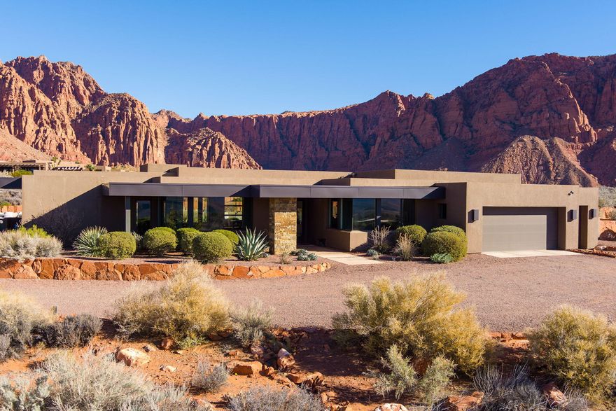 Set on over two private acres in the heart of Kayenta, this extraordinary residence is a true sanctuary where refined design meets the raw beauty of the desert landscape. Thoughtfully positioned to capture nearly three hundred sixty degree views, the home is wrapped in glass, light, and scenery, allowing the outdoors to become an ever present part of daily living. From the moment you enter, the architecture and flow invite both serenity and connection. Two luxurious primary suites offer private retreats, while a designer chef's kitchen anchors the home with Brazilian and Neolith granite, top of the line Miele appliances, and a Sub Zero refrigerator with integrated air purification. Expansive mitered glass windows dissolve the boundary between inside and out, filling the home with natural light and framing the iconic red rock surroundings from nearly every room.

The residence is fully integrated as a smart home and features an eight zoned radiant floor heating system, providing effortless comfort year round. Custom walnut cabinetry and doors, paired with Restoration Hardware lighting and furnishings, elevate each space with warmth and timeless sophistication. A thoughtfully designed flex room adds versatility, adapting seamlessly to your lifestyle whether for work, wellness, or creative pursuits.

Outside, privacy and luxury continue. A heated saltwater pool and spa create a resort like setting, complete with a dedicated pool equipment house and a secluded outdoor shower. Multiple outdoor living spaces invite you to gather, unwind, or simply take in the stillness and beauty of Kayenta. A pergola with additional storage, a three car garage with extra depth and height, and fully xeriscaped grounds ensure both function and ease of living.

This is more than a home. It is a place of peace, presence, and elevated living, designed for those who value privacy, craftsmanship, and breathtaking views in one of Southern Utah's most inspiring communities.
