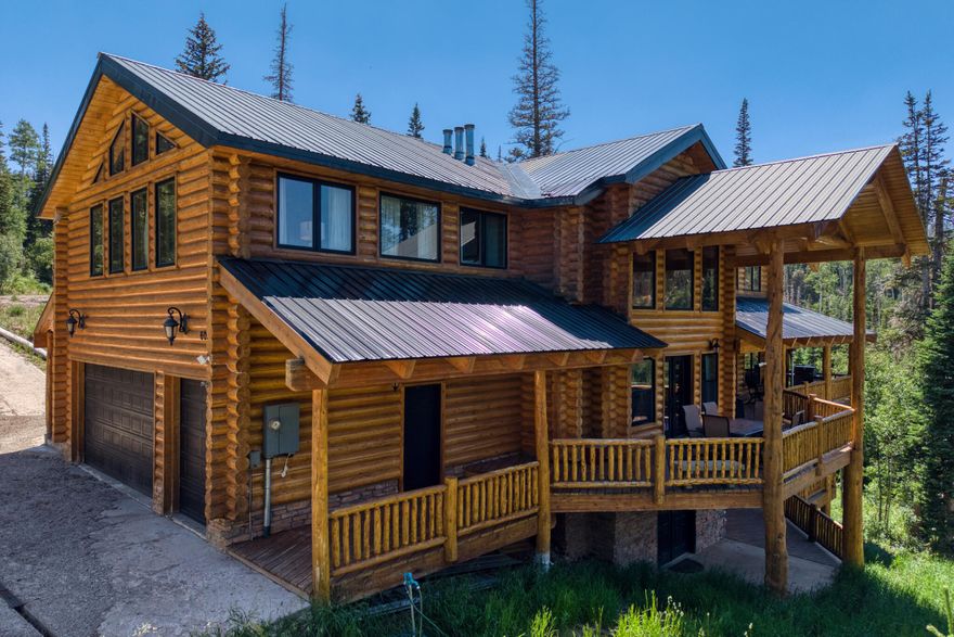 Nestled on a sprawling .60-acre lot, this luxurious log cabin is a perfect blend of rustic charm and modern amenities. With 5 bedrooms, including two bedrooms that are designed as suites with their own fireplaces, adding warmth and luxury, 4 full bathrooms and a loft that offers additional space. The gourmet kitchen design with granite countertops and custom cabinets is equipped with high-end Viking appliances, wine cooler and a large island for meal preparation and gatherings. The basement features three bedrooms and a spacious family room with a fireplace, perfect for cozy nights or hosting guests. Two decks with amazing views. This high-end log cabin is not just a home; it's a retreat that invites you to experience the beauty of nature with the comfort of modern living. Whether you're looking to entertain friends and family or find a peaceful escape, this property offers it all.