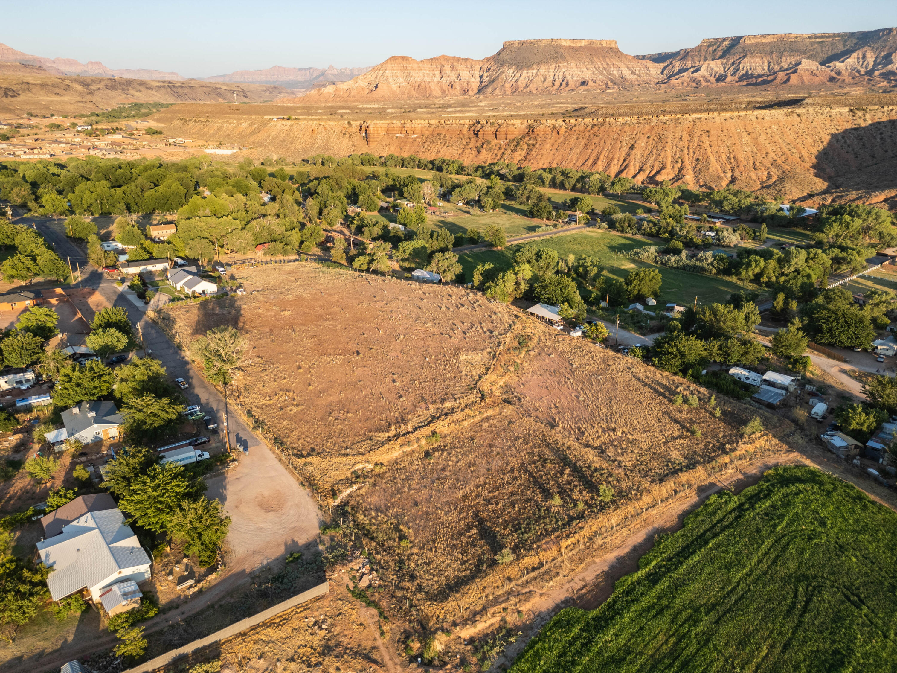 Rare residential land available just minutes from Zion National Park. Zoning allows for 1 acre residential lots, making this a great opportunity for developers. Seller open to selling each 5 acre parcel separately or all 10 acres together. 8.5 water shares for the upper 5 acres (V-77-b) provided through Virgin Canal Company. Each water share irrigates 1/8 acre. 6 water shares for the lower 5 acres (V-77-c) provided through Virgin River Irrigation.