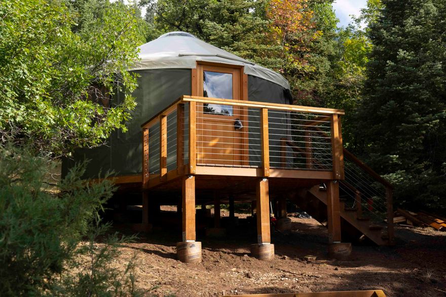 You'll love this newly constructed private GLAMPING PARADISE on this secluded, wooded .62-acre lot near Navajo Lake! Enjoy a cozy 16' forest green yurt with wood floors, insulated walls/ceiling, three windows, and an openable skylight dome. Outdoor amenities include a kitchen/dining area, fire pit lounge, solar power, water hauling system, and a bath house with heated outdoor shower and composting toilet system. You'll love the refreshing mountain temps and the proximity to Navajo Lake, hiking and mountain biking trails, paddleboarding, rock climbing, and more—all within a 15-minute drive. Perfect for summer getaways! Your mountain retreat awaits.