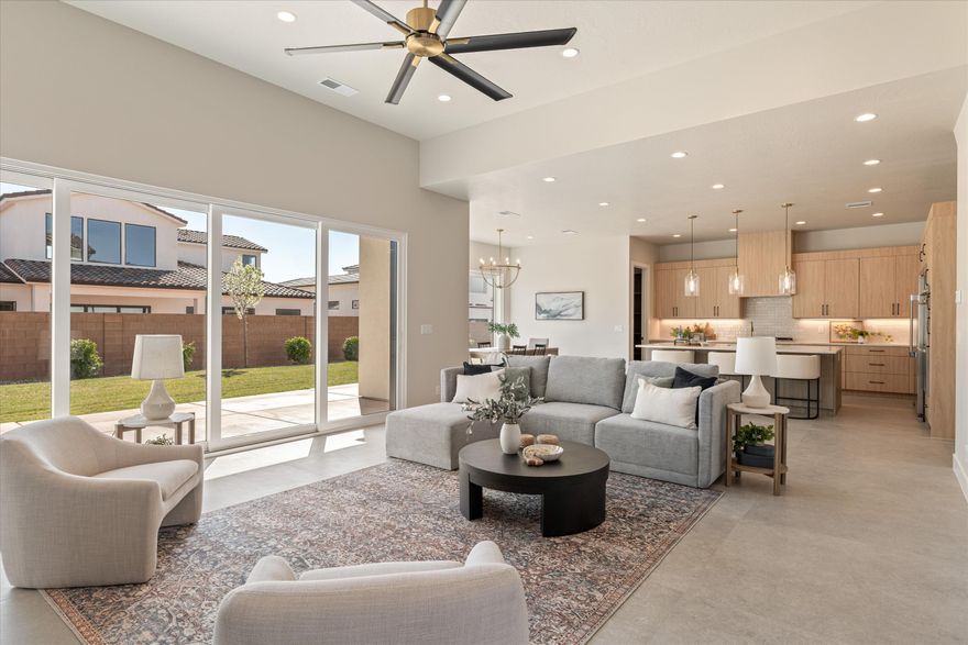 The finishes in this home truly set it apart. Extra-tall ceilings make every room feel grand, while a stunning 12' fireplace anchors the main living space alongside 10' triple sliding doors that blur the line between indoor & outdoor living.
The primary ensuite is unforgettable, featuring a dramatic double shower with 5 walls of glass that enclose a freestanding tub as the centerpiece of the room. A wrap-around closet with custom cabinetry extending to the ceiling delivers both luxury & storage.
Every surface has been thoughtfully designed to balance beauty with function. Enjoy views of the Red Cliffs Temple from the upper level or expansive southern views from the back deck.
The RV garage fits even the largest models, offering 52' of depth & a 12' wide by 14' tall door. Plus No HOA! Backyard is stubbed for a pool. Located in Dixie Power grid. Next to George Washington Academy and near Crimson High School.