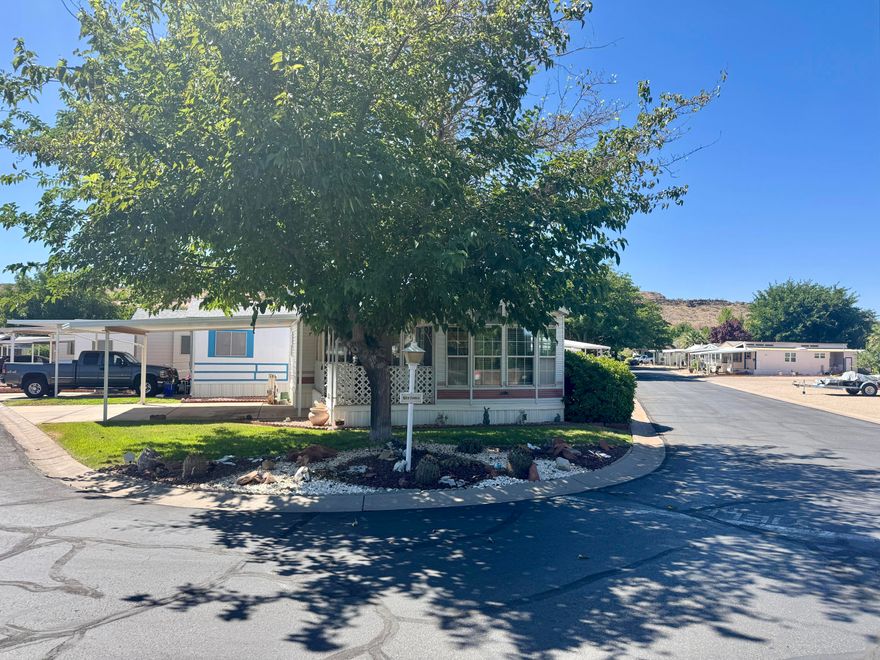 Immaculate 2 bed, 2 bath home on a desirable corner lot! Great sitting porch, covered front parking plus extra parking in the back. Lots of windows bring in natural light. Shade trees, grass, and a peaceful setting. Partly furnished and move-in ready!  Buyer to verify all information.