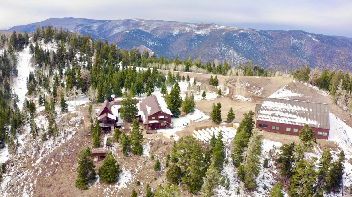 Beautiful mountain retreat with a huge 11,263 sq ft cabin, game room, large gathering room, 12 bedrooms and many bathrooms, walk-in freezer. Expansive deck area, overlook, fantastic 13000 sq ft activity center. Multiple propane tanks. Culinary well.