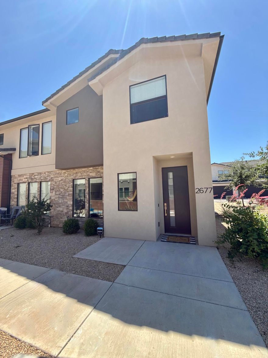 Beautiful end-unit townhome in the highly desirable Woodland Estates community! This immaculate 3 bedroom, 2.5 bathroom home features an open and functional floor plan with 9-foot ceilings that make the space feel bright and spacious throughout. The main level offers a comfortable living area, stylish kitchen with ample counter space, dining area, and convenient half bath--perfect for everyday living and entertaining. Upstairs, you'll find generously sized bedrooms, full bathrooms, and a stunning primary suite complete with a walk-in closet.  Enjoy resort-style HOA amenities including a pool, lazy river, hot tub, pickleball courts, parks, and playgrounds. Ideally located just off Mall Drive near Dino Crossing, Lin's Market, Revere Health, schools, shopping, dining, and more. This move-in ready end unit combines comfort, convenience, and an incredible lifestyle opportunity! Smart TV in upstairs owners suit also included.