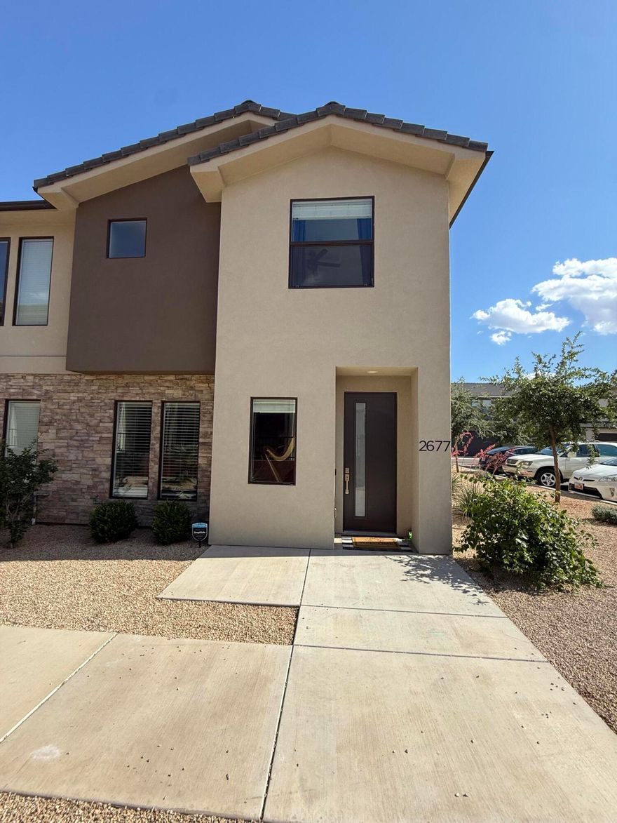 Beautiful end-unit townhome in the highly desirable Woodland Estates community! This immaculate 3 bedroom, 2.5 bathroom home features an open and functional floor plan with 9-foot ceilings that make the space feel bright and spacious throughout. The main level offers a comfortable living area, stylish kitchen with ample counter space, dining area, and convenient half bath--perfect for everyday living and entertaining. Upstairs, you'll find generously sized bedrooms, full bathrooms, and a stunning primary suite complete with a walk-in closet.  Enjoy resort-style HOA amenities including a pool, lazy river, hot tub, pickleball courts, parks/playground. Ideally located just off Mall Drive near Dino Crossing, Lin's Market, Revere Health, schools, shopping, dining, and more. This move-in ready end unit combines comfort, convenience, and an incredible lifestyle opportunity! Smart TV in upstairs owners suit also included.
