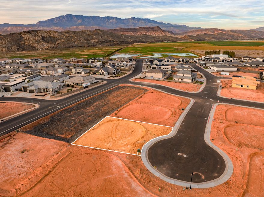 A short RZR ride from Sand Hollow Reservoir and the sand dunes, adventure starts at your garage door. Lot 47 is elevated above a storm water basin and offers a stunning unobstructed view! Build your home base for adventure in Phase 2 of Sand Hollow Village. This lot was made for people with toys—ideal for a modest home with a massive RV garage. Keep your camper, boat, side-by-side, Jeep, and motorcycles...all the gear...on site and skip the storage unit. A place to launch big weekends, unwind after long days outside, and settle in for the long haul—whether you're growing a family or easing into retirement. Friendly, clean neighborhood with sensible CC&Rs that protect quiet enjoyment. No snooty HOA. All builders welcome. Call for an introduction to a home builder.