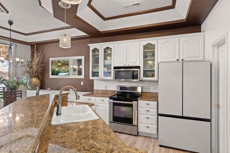 Enjoy golf course living with this beautifully updated 2 bedroom, 2 bathroom townhouse. Freshly painted and featuring brand-new flooring throughout, this home feels move-in ready from the moment you step inside. The open-concept layout creates a bright, welcoming space that flows easily from the living area to the kitchen and dining. Both bedrooms are spacious, each offering its own private bathroom. Outside, a private patio provides the perfect spot to relax or entertain, all while being just steps away from the fairway. Offering low-maintenance living in a desirable golf community, this townhouse is ideal as a full-time residence, second home, or investment property.