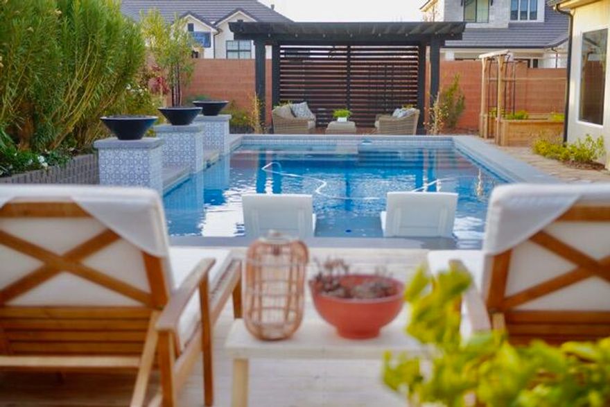 Luxury Home - Over $200,000 in Premium Upgrades This stunning home showcases over $200,000 in premium upgrades and offers the perfect blend of luxury, privacy, and functionality on a fully landscaped corner lot with a gated yard. Enjoy resort-style outdoor living featuring a saltwater pool with lit waterfalls and fire bowls, a high-end ACCOYA wood pool deck, and low-maintenance Mediterranean landscaping with flagstone pathways. The pergola is stubbed with gas for a future outdoor fireplace or kitchen, and the large covered patio creates the ultimate entertaining space. A custom metal driveway ramp accommodates low-profile
vehicles. Inside, you'll find hardwood floors throughout, quartz countertops, white oak cabinetry, and a fireplace with built-in shelving. The primary suite features a custom 8-ft frameless glass shower door, and motorized shades add convenience in the primary bedroom, living room, kitchen dining area, and upstairs family room. Tinted windows provide added privacy and energy efficiency. Additional highlights include a brand-new Bosch dishwasher, upgraded Café appliances, cedar garden grow boxes, mature fruit trees, and thoughtful upgrades throughout that make this property truly move-in ready.