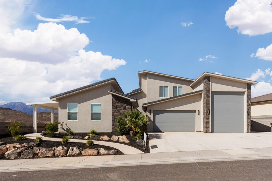 Experience one of the most iconic views in Southern Utah from this meticulously maintained home. Situated to capture the red rocks of Sky Mountain and the peaks of Pine Valley, this property balances high-end finishes with practical, everyday utility. The heart of the home is a vaulted great room with floor-to-ceiling stone work fireplace and large windows that frame the landscape. The kitchen is built for performance, featuring herringbone tile, under-cabinet lighting, and upgraded Gourmet GE Profile appliances.

A standout feature is the versatile casita, which offers a private living room, kitchen, and laundry hookups, perfect for short term guests or long-term family needs. For those with toys, the oversized RV garage is a true workshop/storage hub, complete with epoxy floors, a 14' door, and full hookups.

Outdoor living is easy here, with a private front courtyard and a backyard designed for low-maintenance enjoyment, featuring custom pavers, artificial turf, and a built-in fire pit. Because this has been used strictly as a secondary residence, the home and the (negotiable) furniture are in like-new condition. With no HOA restrictions, you have the freedom to enjoy this property exactly how you want.