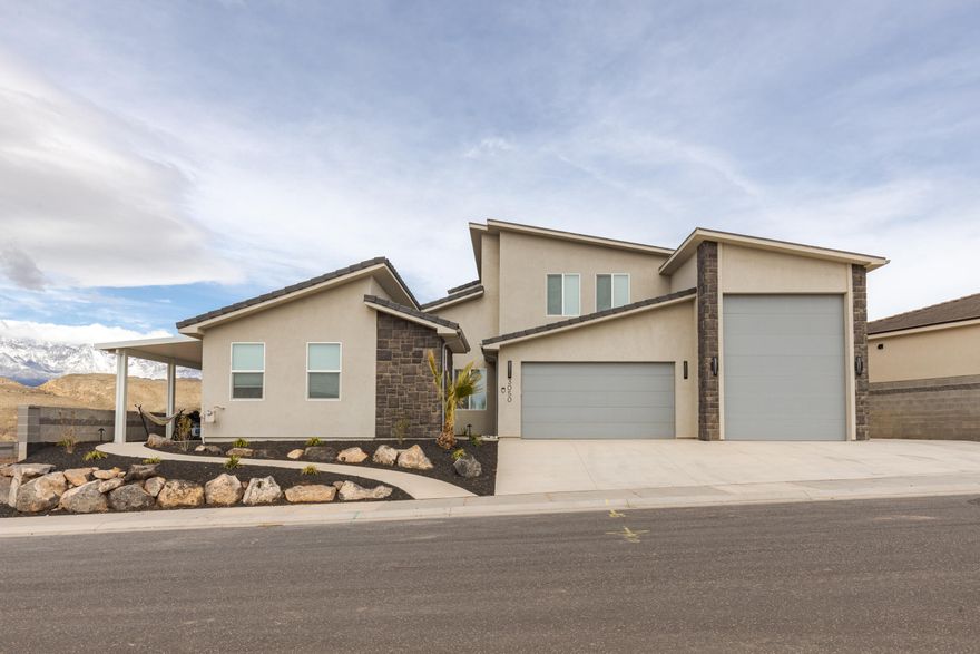 Experience one of the most iconic views in Southern Utah from this meticulously maintained home. Situated to capture the red rocks of Sky Mountain and the peaks of Pine Valley, this property balances high-end finishes with practical, everyday utility. The heart of the home is a vaulted great room with floor-to-ceiling stone work fireplace and large windows that frame the landscape. The kitchen is built for performance, featuring herringbone tile, under-cabinet lighting, and upgraded Gourmet GE Profile appliances.

A standout feature is the versatile casita, which offers a private living room, kitchen, and laundry hookups, perfect for short term guests or long-term family needs. For those with toys, the oversized RV garage is a true workshop/storage hub, complete with epoxy floors, a 14' door, and full hookups.

Outdoor living is easy here, with a private front courtyard and a backyard designed for low-maintenance enjoyment, featuring custom pavers, artificial turf, and a built-in fire pit. Because this has been used strictly as a secondary residence, the home and the (negotiable) furniture are in like-new condition. With no HOA restrictions, you have the freedom to enjoy this property exactly how you want.