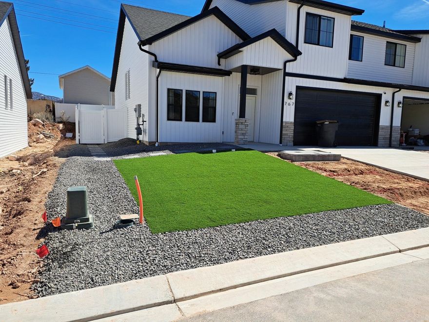 Beautiful newer built 2-story home. Open ﬂoor plan with long entryway and vaulted ceilings. The large windows allow plenty of natural light into the home. Quarts countertops and stainless steal appliances with plenty of cabinetry and a island/bar top for entertaining. Entry from garage into home with mudroom for personal storage. Oversized with double door entry bedroom downstairs across from 1/2 bathroom. Switchback stairs with rod iron railing with an gorgeous open landing at the top of stairs. Laundry is conveniently located upstairs next to primary bedroom. Large primary bedroom with spacious walk-in closet with plenty of storage. Primary bath has a walk in shower with dual vanities. Both front and backyard are fully landscaped/ hardscape done professionally with
turf, pavers, putting green, and a hot tub. Lighted front entry steps give this home true curb appeal. 5 minutes away from SUU.