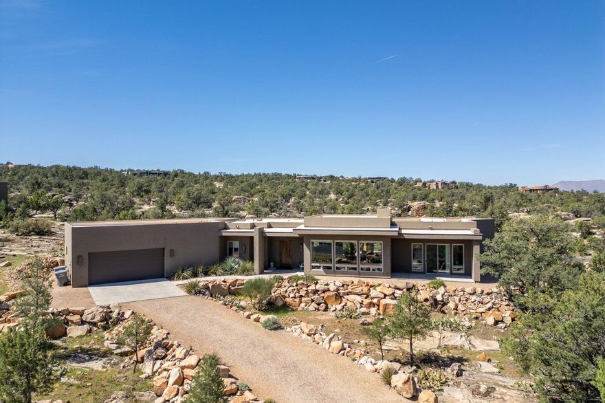 Welcome to Pinion Hills. Set on a full acre and built in 2016, this elevated home captures sweeping panoramic views and is surrounded by pinion trees whose fresh, earthy scent greets you on arrival. Conveniently located just 20 minutes north of St. George--where temperatures typically run about 10 degrees cooler--you'll enjoy a more comfortable climate without sacrificing access to town.

Inside, the home offers 3 bedrooms and 2 bathrooms, with one currently used as an art studio--ideal for creative space or a quiet office. Concrete floors run throughout, providing a clean, modern look with easy upkeep, while large windows fill the home with natural light and keep the views front and center.

An oversized garage adds flexibility for storage, hobbies, or outdoor gear. Low-maintenance and thoughtfully positioned, this property offers space, privacy, and a setting that feels calm, open, and distinctly Southern Utah.