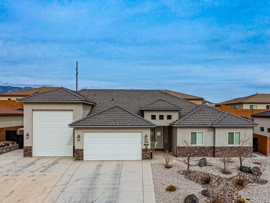 This one checks so many boxes! Open spacious gathering areas in the main part of the interior, including an open kitchen with modern appointments. Ample primary bed and bathroom area, wall mounted TV included, 3 other bedrooms for guests or dependents, desert landscaping for ease of use with some grow boxes and garden spot including productive blackberry bushes. Cement skirting around entire parameter of the yard, Add the Massive 1229 feet of garage space with ample door height and 53' foot length for a large class A RV, including an exterior covered parking or work area, and so much more.  Come and check it out before it slips away.