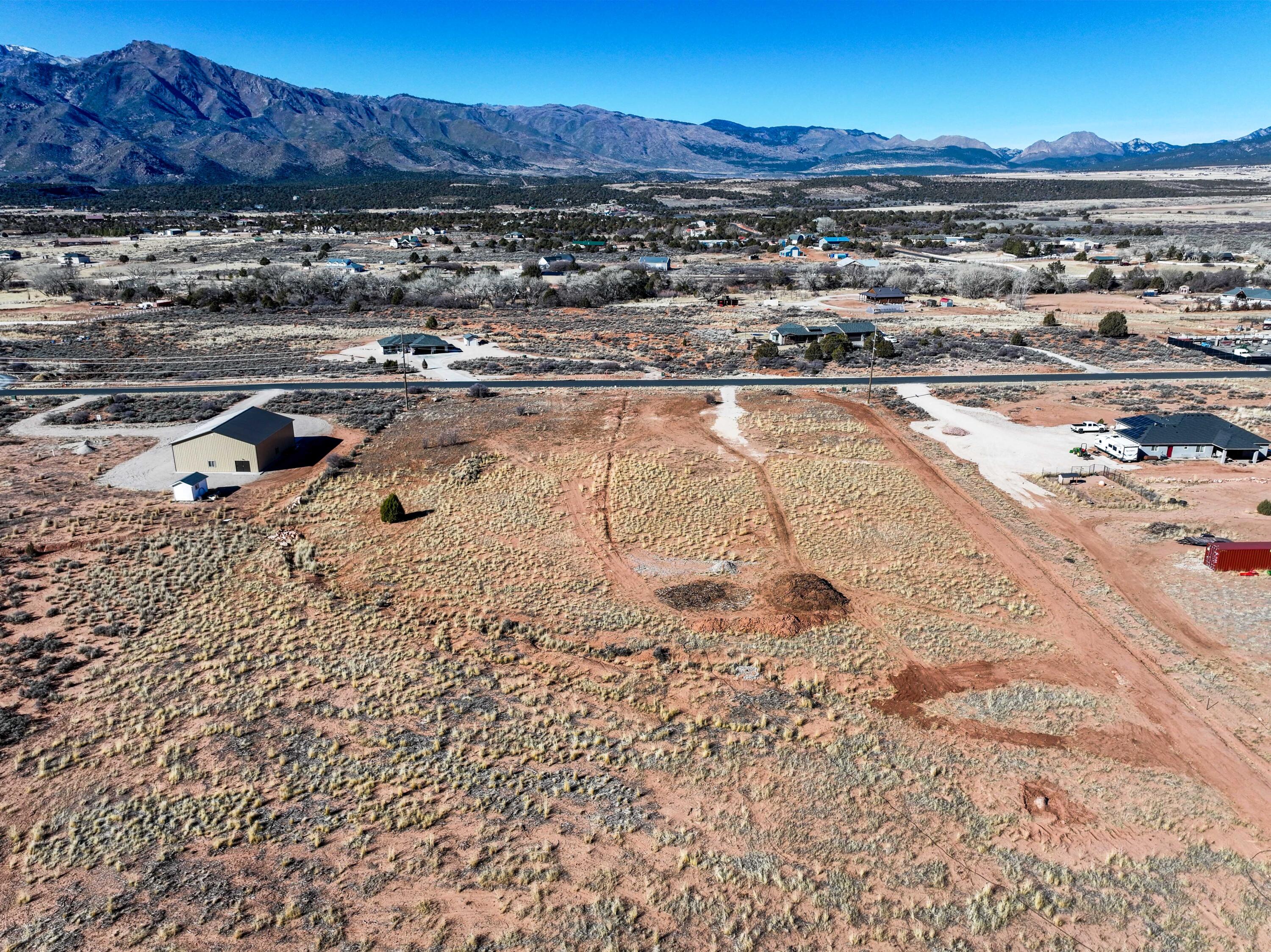 360 degrees of breathtaking views! Build your dream home on this perfectly situated, boasting panoramic views of Pine Valley Mountain, Kolob Canyon, and Zion National Park. Conveniently located with easy access to I-15, you're just minutes from St. George or Cedar City, offering both serenity and accessibility. 

This lot comes with water already paid for and stubbed in and other utilities include electricity and gas. With paved roads throughout the community, you'll have a smooth and easy path to your new home. 

Do not miss this opportunity to own a piece of paradise and make your dream home a reality. Includes ONE water share from Mountain Springs Water Co.