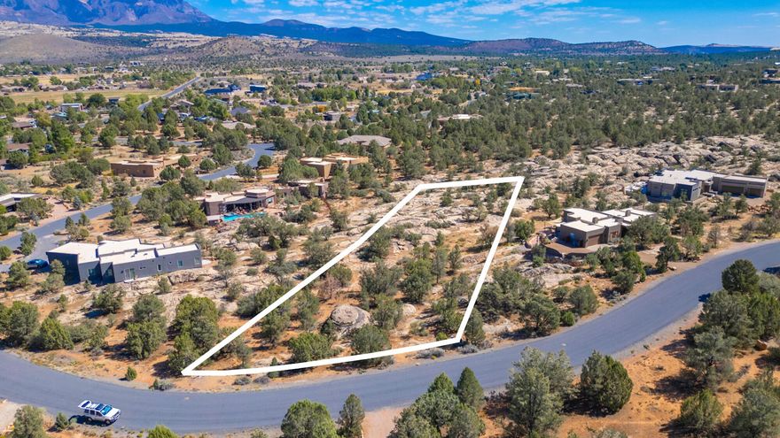 Build your dream home on this 1.29-acre lot in the highly desirable Pinion Hills subdivision of Dammeron Valley. This property offers expansive mountain views, unique rock formations, and mature junipers that provide natural beauty and privacy. Situated on a quiet, paved road with city culinary water, natural gas, and sewer already stubbed to the lot, it's ready for your custom build.
The terrain features striking sandstone outcroppings, giving the lot character and multiple design possibilities for a home that blends with the landscape. With CC&Rs to protect neighborhood quality but the freedom to bring your own builder, you can create a one-of-a-kind residence in a peaceful, upscale community. Located just minutes from St. George, you'll enjoy cooler summer temperatures, open skies,