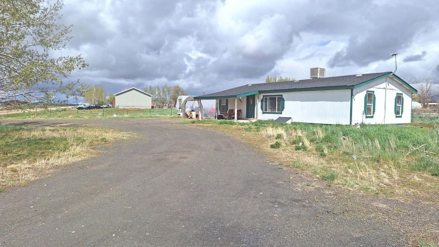 Single-level home on a spacious rural, horse property lot set in a quiet area with beautiful mountain views. Interior features a functional layout with open living space, laminate flooring, and a large kitchen and dining area. Main floor includes 3 bedrooms and 2 full bathrooms. The 1 acre yard provides space for animals, gardening, or future improvements. The property also includes an outbuilding for equipment or hobby use. No HOA. This neighborhood shares a community well. Home is located near the Hamilton Fort exit.