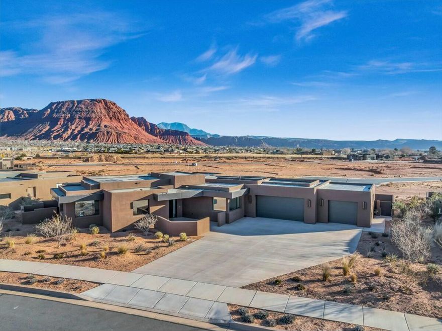 Modern sophistication meets desert serenity in this never-lived-in Ivins masterpiece, now reintroduced with a $50,000 price improvement. Thoughtfully designed to showcase Southern Utah's iconic red-rock landscapes with floor-to-ceiling windows that fill each room with natural light and perfectly frame breathtaking Snow Canyon views.

Every finish reflects craftsmanship and intention from custom cabinetry and premium appliances to spa-inspired bathrooms and an oversized 3-car garage with ample room for a UTV or adventure gear. The seamless indoor-outdoor design invites connection to desert breezes and star-filled night skies, protected by Indigo Trails' exclusive dark-sky community standards. Ideally situated just minutes from Snow Canyon State Park, Kayenta Art Village, Black Desert PGA Golf Course and endless hiking and biking trails, this home offers the perfect blend of luxury, privacy, and proximity to all St. George amenities. Furniture package negotiable. Schedule your private tour and experience modern desert living at its finest, today.