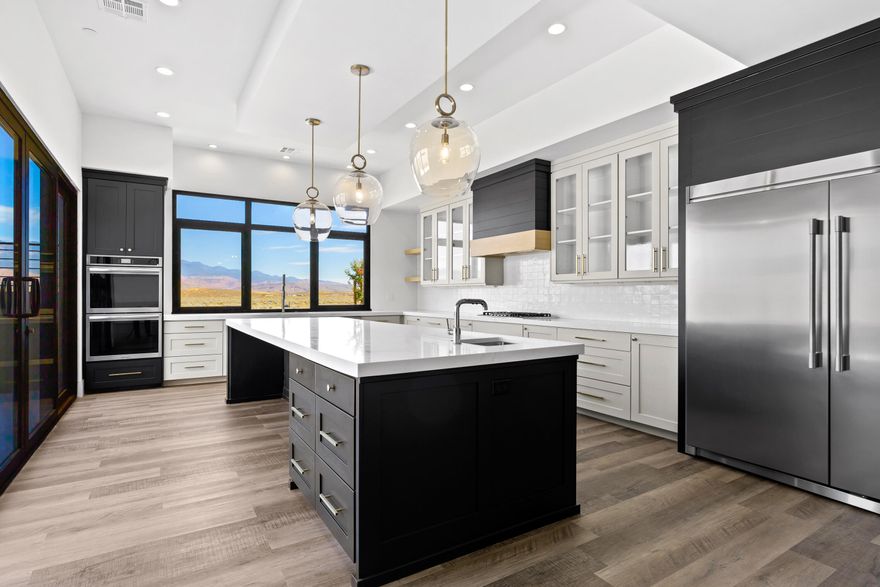 Brand new, custom-built single-level home in the heart of Southern Utah's outdoor playground! Just 7 minutes from Sand Hollow Reservoir, State Park, and Championship Golf Course, this high-end designer home was built for entertaining and relaxation. Step into expansive open-concept living with a chef's kitchen featuring double ovens, a drop-in cooktop with vented hood, oversized Subzero fridge/freezer, dual sinks (including one in the stunning 13-foot island), and a picturesque window above the main sink framing Pine Valley Mountain. The seamless indoor/outdoor living is made possible by a large sliding glass door that opens to a private patio with a 16-person hot tub, built-in gas stub for BBQ, and no rear neighbors. Enjoy gorgeous views from the massive rooftop deck with its own gas stub for a future fire pit. Durable, carpet-free flooring throughout, an oversized 2-car garage with utility sink, water softener, and hot water recirculation pump add to the thoughtful touches. The home is equipped with a fire suppression system, offering both safety and potential insurance savings. Zoned for nightly/weekly rentals, however, this particular home is not currently approved for short-term rental use due to HOA restrictions.