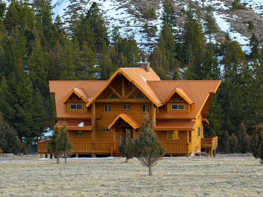 Welcome to a rare gem in Southern Utah-where natural beauty meets mountain elegance. This custom-built, three-level trophy cabin spans approximately 3,706 sq ft and sits on a sprawling 9.71-acre parcel with a private well (.5 Acre Ft). Designed with exceptional craftsmanship and attention to detail, the home offers an open, flowing layout and upscale finishes throughout.Soaring vaulted ceilings and a wall of windows flood the main-level living room with natural light, centered around a stunning rock-accented, wood-burning fireplace-perfect for cozy gatherings. The gourmet kitchen is a chef's dream, featuring stainless steel appliances, a gas double-oven range with hood, custom oak cabinetry, a walk-in pantry, 3' granite countertops, and a soft white stone backsplash. With 5 spacious bedrooms and 4 bathrooms, there's room for everyone. The main-level primary suite includes a luxurious en suite bathroom with dual sinks and a beautifully tiled walk-in shower. Unwind on the covered back deck and let the peaceful sounds of Mammoth Creek soothe you-nature's lullaby right outside your door. Meticulously maintained and built to last, this is mountain living at its absolute finest.