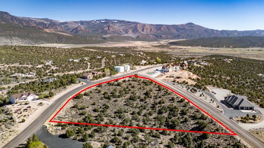 Exquisite 3-acre treed corner lot in desirable Cross Hollow Hills, offering multiple ideal building sites for your custom home. The gentle, gradual slope is perfect for a walk-out basement, while the elevated setting captures breathtaking, unobstructed sunset views. Enjoy privacy, space, and the natural beauty of Southern Utah, all just minutes from Cedar City. Water is provided through Iron County Water Conservancy, with power, gas, and other utilities conveniently located in the street for easy access. A rare opportunity to build your dream home in a premier setting.