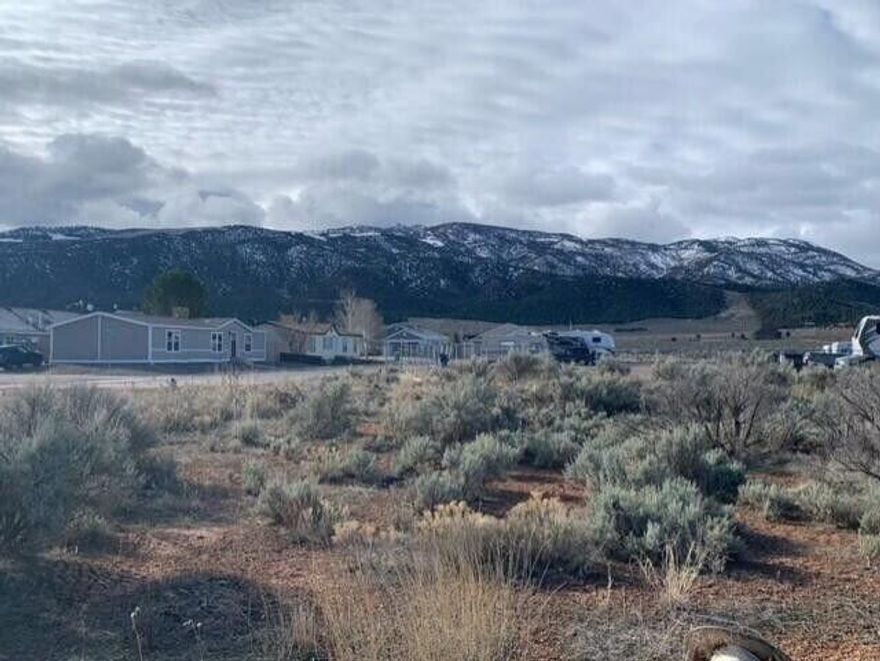 Uncover the potential of this expansive land property located in the picturesque Parowan, UT 84761. Offering a rural ambience with stunning views of lush mountains, this space provides an ideal backdrop for building a custom home or setting up a tranquil retreat. Spanning a generous area, the land is dotted with native vegetation, adding to its serene and untouched charm. This property benefits from being situated in a developed neighborhood, with nearby homes and accessible roads ensuring convenience and connectivity. Utilities are in close proximity, simplifying the logistics of construction and daily life. Enjoy the flexibility of use, whether for residential development or as a recreational getaway.