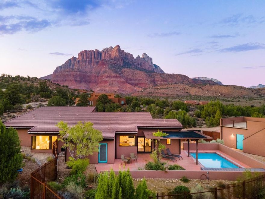 Nestled on the Anasazi Plateau, this Springdale sanctuary invites you to experience a life woven seamlessly with the beauty of Zion. Just moments from the park's entrance, this 3-bedroom, 2.5-bath retreat offers more than a home—it offers a rhythm of living in harmony with nature's grandeur.

From sunrise to sunset, every window becomes a frame for red cliffs and desert skies. Step outside to your private swimming pool, where the stillness of the plateau meets the shimmer of water, or ascend to the rooftop deck for sunsets, gatherings, and unforgettable starlit evenings beneath the clearest skies imaginable. This is a place where mornings begin with mountain light, evenings linger by the pool, and nights sparkle with infinite stars. A true haven for the soul, it's more than a residenceit's an escape, a romance with the land, and an invitation to live beautifully in Springdale.

This is not just a homeit's a rare opportunity to claim a front-row seat to the wonders of Zion, all while enjoying modern elegance and the tranquility of Springdale living.