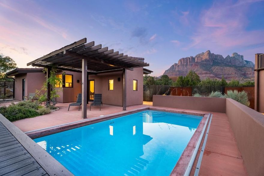 Nestled on the Anasazi Plateau, this Springdale sanctuary invites you to experience a life woven seamlessly with the beauty of Zion. Just moments from the park's entrance, this 3-bedroom, 2.5-bath retreat offers more than a home—it offers a rhythm of living in harmony with nature's grandeur.

From sunrise to sunset, every window becomes a frame for red cliffs and desert skies. Step outside to your private swimming pool, where the stillness of the plateau meets the shimmer of water, or ascend to the rooftop deck for sunsets, gatherings, and unforgettable starlit evenings beneath the clearest skies imaginable. This is a place where mornings begin with mountain light, evenings linger by the pool, and nights sparkle with infinite stars. A true haven for the soul, it's more than a residenceit's an escape, a romance with the land, and an invitation to live beautifully in Springdale.

This is not just a homeit's a rare opportunity to claim a front-row seat to the wonders of Zion, all while enjoying modern elegance and the tranquility of Springdale living.