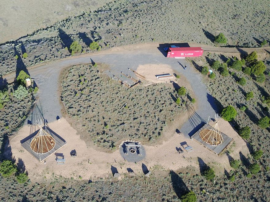 This property boasts 13 acres with three hills for endless possibilities. Take advantage of this rare gem sitting above Hwy 89 with a 360 degree picturesque view of the red rock canyons. Look out to miles of ranch land and the Severe River running alongside Hwy 89. Backside property line is BLM land and suggests that you won't have to worry about anyone building behind you. The property is partially fenced with a gate at the entrance. Electricity is available, located at the gate entrance. On the second hill, there is a permitted water well with 1 acre water rights and brand new septic tank installed. No development has occurred on the third hill.
The current owners used the first hill as a tipi vacation rental site and have installed three wooden floating decks. New owners can turn these decks into camping/picnic sites and even install RV facilities! The 40ft shipping container is currently a storage but can be turned into a tiny home or office.
Take a drive or walk over to the second hill. With plans to build three wooden yurts, this dream getaway could come to fruition with the right person. The current owners put a lot of thought, effort, and hard work into starting the project and are willing to turnover the permitted plans/drawings with the sale of the property. The 3 ft concrete foundation has been installed and the first, largest 30 ft yurt has been constructed. Materials for the bump outs to the two other 20 ft yurts are available but the two 20 ft yurts still need to be purchased and constructed. A brand new septic tank has been installed in front of the yurts and the property comes with a permitted water well and 1 acre water rights.
As a commercially zoned property there is boundless potential, don't let this rare opportunity pass you by!