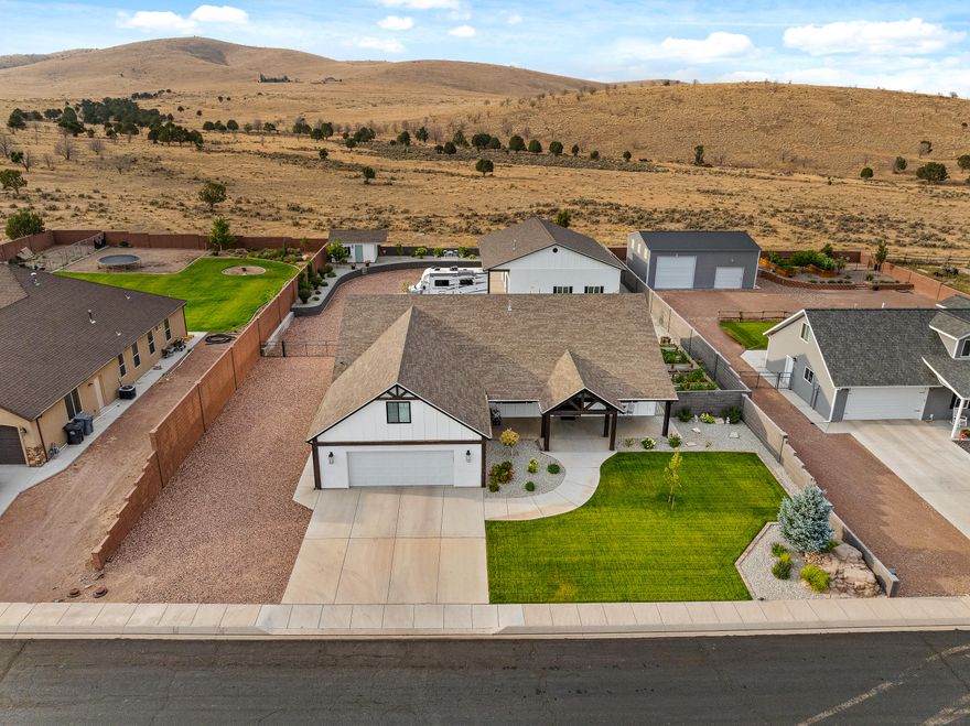 Custom Country Dream Home w/ Stunning Mountain Views. Built in 2017, 3,311sqft w/ 4 beds (2 masters), 4 baths, large 0.51 acre lot w/ an oversized attached 2-car garage (710 sqft) w/ epoxy/sealed flooring & new garage cabinets. Updated with new windows, new entry door, new LVP flooring. Large chef's kitchen w/ all the upgrades of granite countertops, custom cabinetry, built-in stove top. Get cozy by the fireplace. Fully fenced yard w/ new landscaping, sprinklers, water feature, garden boxes w/ sprinkler system & gazebo w/ an outdoor kitchen area. The heated and insulated 50x35 (1,400 sqft) 6 car double door shop is a craftsman's delight, w/ 50 amp RV hookup w/ clean out. Shop has an attached office/bedroom (w/ mini split) and full bathroom with ample storage above shop office.A must buy!