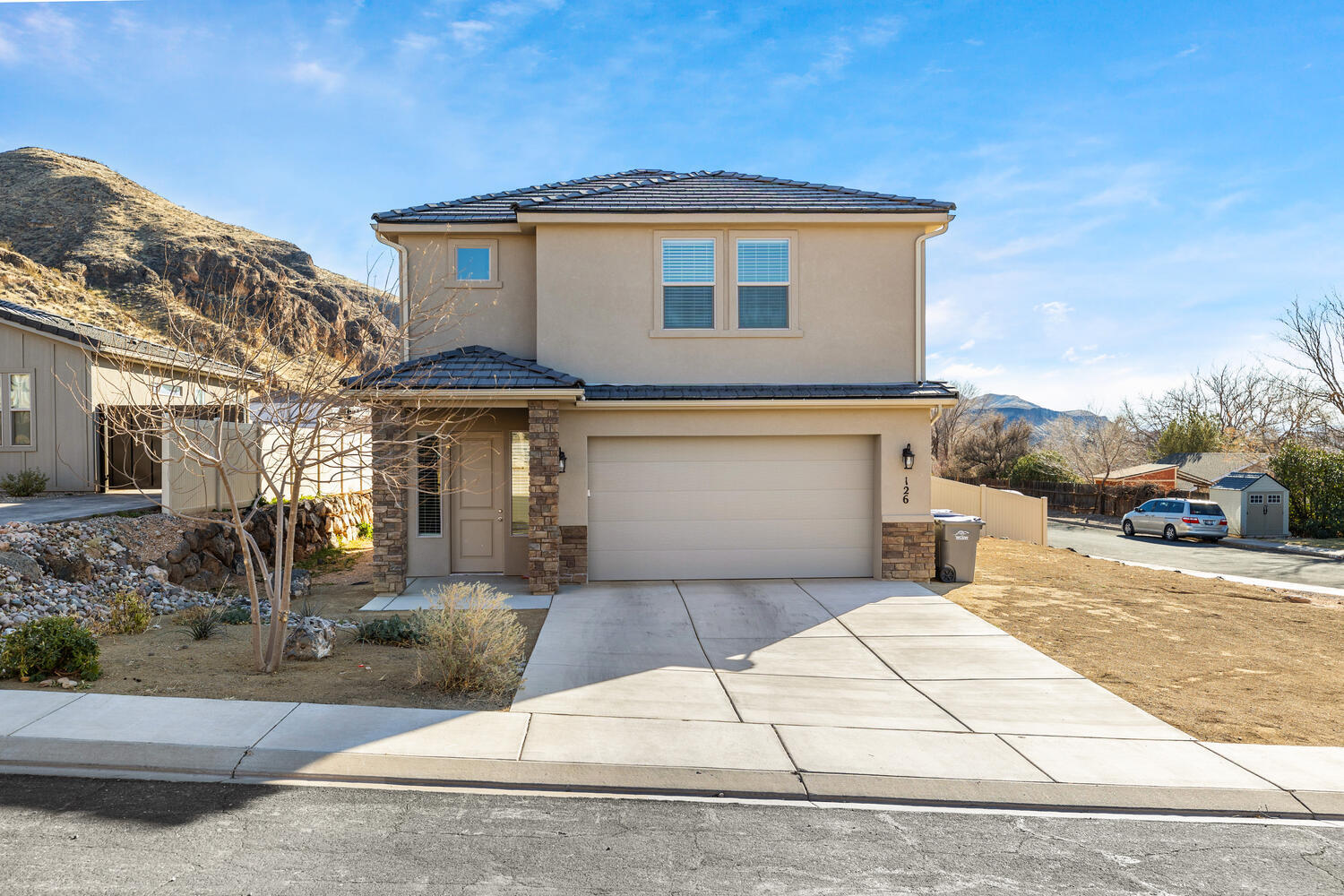 Nearly brand new construction meets flexible living in this contemporary 4-bedroom home, framed by breathtaking hill and mountain views. Completed in 2022 with no HOA, the property spans nearly a quarter acre, offering a large yard that could accommodate an ADU for added
income. Inside, an open-concept layout unites living area, kitchen, and dining, complemented by durable LVP floors and abundant natural light. The chef's kitchen shines with contemporary Shaker cabinets, white quartz counters, stainless appliances, and a spacious breakfast-bar island. Upstairs, the primary suite boasts a walk-in closet with custom organizers and an ensuite bath featuring double sinks and a walk-in shower. Two additional bedrooms share a hall bath, also with double sinks. A handy laundry room, ready for your washer and dryer, and a finished two-car garage with storage rack add convenience. Enjoy outdoor living in the covered back patio and low-maintenance yard, with upgraded fencing for privacy, all nestled in the scenic foothills of La Verkin Overlook. With local restaurants and amenities close by, plus Zion National Park just a short drive away, this home offers the perfect balance of scenic tranquility and everyday practicality. Come in, relax, and let each day unfold with a new adventure.