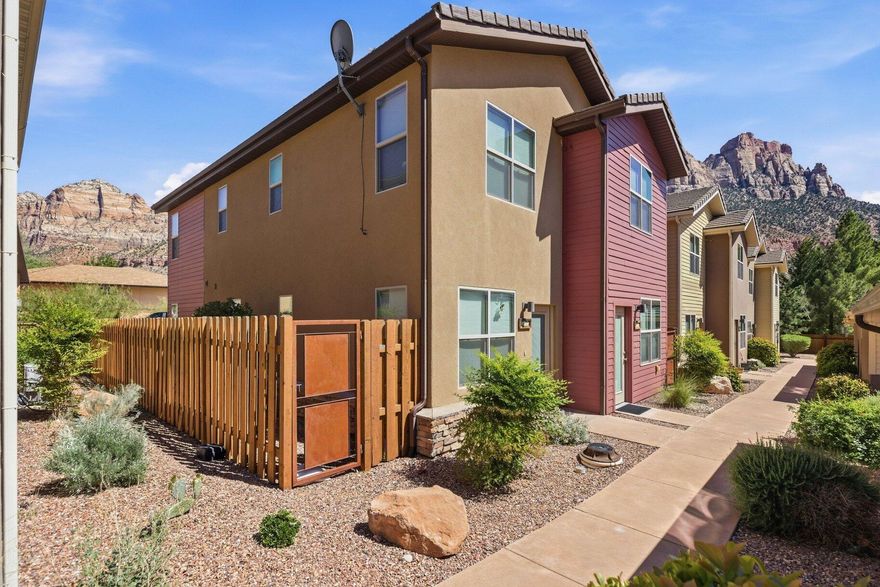 Located in the heart of Springdale, this two-story townhome is the epitome of comfortable, effortless living. Just a short stroll from vibrant restaurants, boutiques, and the free shuttle to Zion National Park, this property brings adventure-ready convenience. The spacious, modern kitchen offers sleek appliances, while the upstairs bedrooms serve as quiet spaces. The outdoor patio is fully fenced, perfect for relaxation and taking in the remarkable surroundings. This home is your gateway to the best Zion has to offer. The unit is approved for a minimum of 30-night/31-day rentals. This is the only residential area within Springdale where you can rent for under 90 days. The home has been very well cared for. No nightly rentals allowed. Furnishings are negotiable.