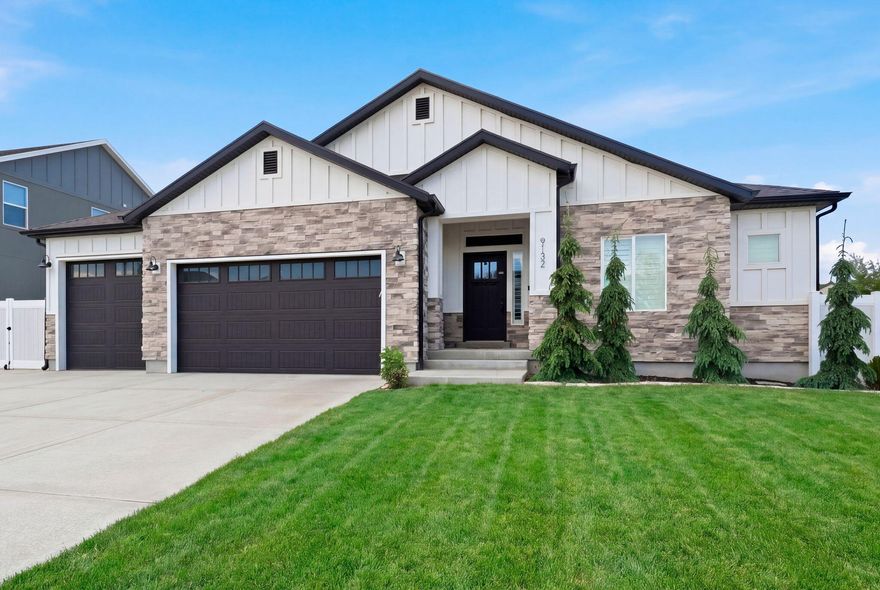 This beautifully designed east-facing rambler offers the perfect blend of comfort, style, and functionality. Formerly a model home, it showcases a bright open layout filled with natural light, soaring vaulted ceilings, rich hardwood flooring, and a cozy fireplace that anchors the main living space. Thoughtful upgrades throughout include plantation shutters, electric blinds, soft-close cabinetry, and high-end appliances in the stunning kitchen, along with a spacious dining area ideal for gathering and entertaining. The luxurious primary suite feels like a private retreat with a spa-inspired bath featuring dual vanities, a separate tub and shower, and an inviting atmosphere designed for relaxation. The finished basement offers incredible flexibility with plumbing already in place for a second kitchen, space for an upright washer and dryer, and the potential to add a separate entrance for an accessory apartment or multigenerational living setup. A dedicated office provides the perfect work-from-home space, while abundant storage keeps everything organized. Outside, enjoy a beautifully landscaped quarter-acre yard complete with mature trees, a spacious backyard deck perfect for evening sunsets, an extra-long RV pad, and a finished three-car garage featuring epoxy floors, ceiling fan. This home truly checks every box