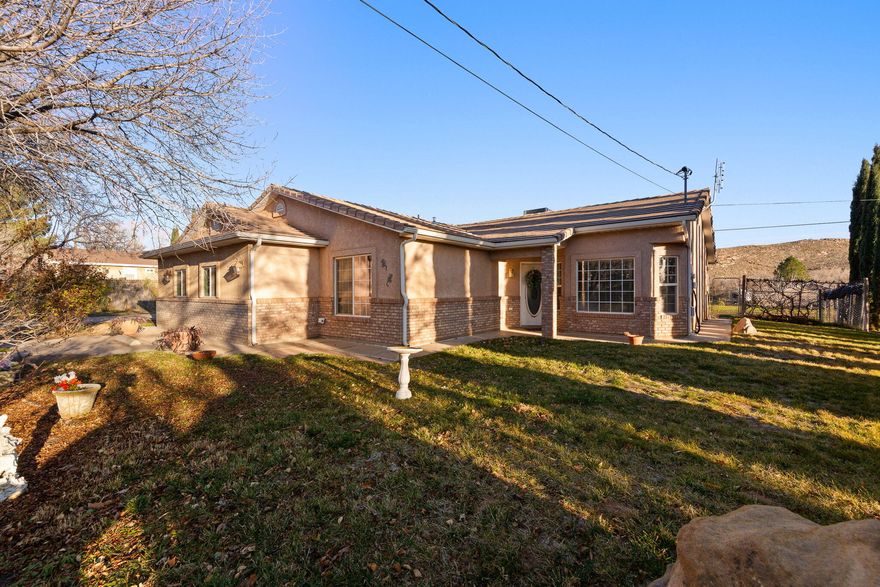 Rare 1.24-acre property located just off Main Street in Leeds with abundant space for boats, RVs, and future expansion. This 4-bedroom, 2-bath home plus den offers flexible living space both indoors and out. Zoned RR-20 for one horse, or two smaller animals, the expansive backyard features mature fruit and nut trees and endless possibilities for gardening, animals, a shop, or future pool. Ideally situated for outdoor enthusiasts—approximately 30 minutes to Zion National Park, 20 minutes to Quail Creek State Park, about 30 minutes to Sand Hollow Reservoir, 10 minutes to Red Cliffs National Conservation Area, and just over an hour to world-class skiing at Brian Head. A rare opportunity to enjoy space, privacy, and exceptional access to Southern Utah recreation.