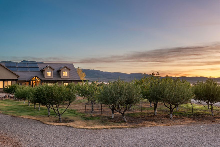 Experience a rare Southern Utah estate where recreational living, privacy, and long‑term land productivity come together. 10-bedroom 5-bathroom estate set on more than 20 irrigated acres, this New Harmony ranch offers two private ponds, a producing orchard, extensive solar infrastructure, and secure water resources, including 20 water shares, a culinary water right, and a 10,000‑gallon freshwater tank.

The 8,762‑sq‑ft residence is designed for year‑round enjoyment with an indoor pool, sports court, multiple gathering spaces, and warm natural materials throughout. Ten bedrooms support flexible living arrangements and effortless hosting. Large windows frame views of Kolob's red rock cliffs, and outdoor spaces invite quiet evenings by the firepit or active day Productive land enhances the property's value with irrigated pastures, orchard harvests, and room for recreation or expansion. Wide open spaces, private ponds, and energysupporting systems create a setting that feels both serene and self-sustaining.

Whether used as a primary residence, private retreat, or multiuse estate, this property offers a rare combination of scale, amenities, and natural beauty that is difficult to replicate anywhere in Southern Utah.