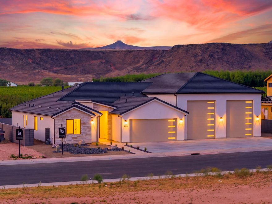 Two RV bays big enough for all your toys--and yes, it's so big we painted a pickleball court inside. Adventure lives here. Just north of Sand Hollow Reservoir and the dunes, this custom home is the ultimate Southern Utah basecamp. 2,498 sq ft of garage--more garage than house--finally a place for the trophies and toys that define your lifestyle. Plumbed for mini-splits to keep it cool in summer and warm in winter. Double RV bays (52' & 65' deep) with 12' wide x 14' tall doors, plus a 24' deep 2-car garage--fair warning, you may need a bigger motorhome. Backing to a peach orchard with an east-facing yard--sunrises, open skies, no rear neighbors. And yes, the house delivers too. Dual primary suites on opposite sides offer space and privacy--ideal for a game room, pool table, or private retreat. Massive backyard with room for a swimming pool--and another court. Rare. Bold. Built for how you actually live. Don't miss it. Seller is a licensed Utah real estate broker.
