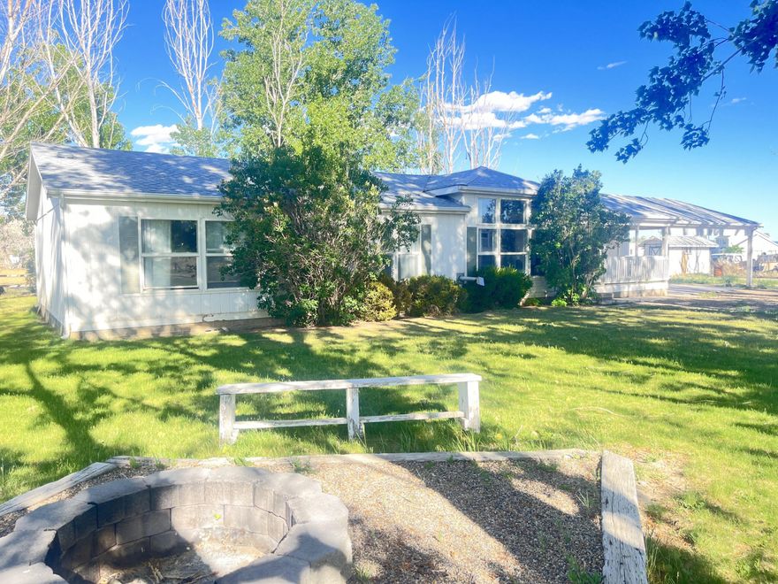 This comfortable single-family home sits on 1.5 acres in Escalante, surrounded by large mature trees for shade and privacy. Inside, tall ceilings and plenty of windows bring in lots of natural light and create an open, welcoming feel. The spacious kitchen and separate dining room make it easy to host family meals or gatherings with friends. The air conditioning unit is just one year old, keeping the home cool and efficient.
The property comes with 1.5 shares of irrigation water to help water its lawn and fruit trees, including cherry, plum, peach, and apricot. A powered workshop provides space for projects or storage, and an additional shed is perfect for yard tools or outdoor gear. 
If you've dreamed of wide open spaces or your own homestead, this property is ready for you.