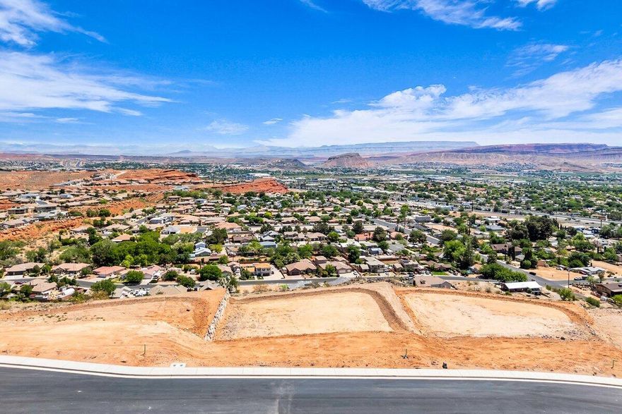 Premier rim view lot with exceptional views overlooking the city, mountains, Pine Valley, red rock mesas, Sand Hollow, and even Zion National Park! Best suited for a walkout floor plan, this lot is located in the final phase of Grand Heights, the highest elevated subdivision in St. George proper, nearly 500 feet higher than the rest of town, including Stone Cliff and Foremaster, offering unmatched views. Enjoy quick access to downtown, hiking and biking trails, and off-road adventures, plus you're just 15 minutes from two major fishing reservoirs and over half a dozen top-rated golf courses. With BLM land bordering the subdivision, you can ride bikes and ATVs straight from your doorstep. Numerous oversized lots are available with convenient highway access. Bring your own builder! Buyer is responsible for water impact fees. All construction requires prior review and approval by the architectural control committee. Buyer to verify all information, deemed reliable, however buyer to verify all info including utilities & ACC information if applicable.