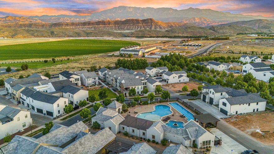 Best value in Marla at Elim Valley-over $100K below assessed value. Turnkey, luxury nightly rental-approved home just minutes from Sand Hollow Reservoir, Sand Dunes, golf courses, and world-renowned Zion National Park. Enjoy year-round recreation with nearby water parks, rope courses, and endless outdoor adventure. Fully furnished and like new, this spacious property features 4 bedrooms (including a large bunk room) and 4 bathrooms, with accommodations for up to 24 guests. Situated on a 0.12-acre corner lot with a 3-car garage and additional parking for large groups. Unique dual-living setup functions like two homes in one. The main residence includes 3 private suites, a full kitchen, dedicated laundry, and expansive living spaces with both living and family rooms, plus a balcony. The enclosed courtyard provides a private outdoor retreat with a spa pool, gas BBQ, fire feature, and gathering area. Detached casita with private entrance offers a full kitchen, laundry, full bath, and enclosed bunk room-ideal for separate rental income, guest quarters, or flexible owner use. Live in one and rent the other, or maximize returns by renting both. Community amenities include two resort-style swimming pools, splash pad, oversized hot tub, clubhouse, pickleball courts, and parking for RVs, boats, and trailers.