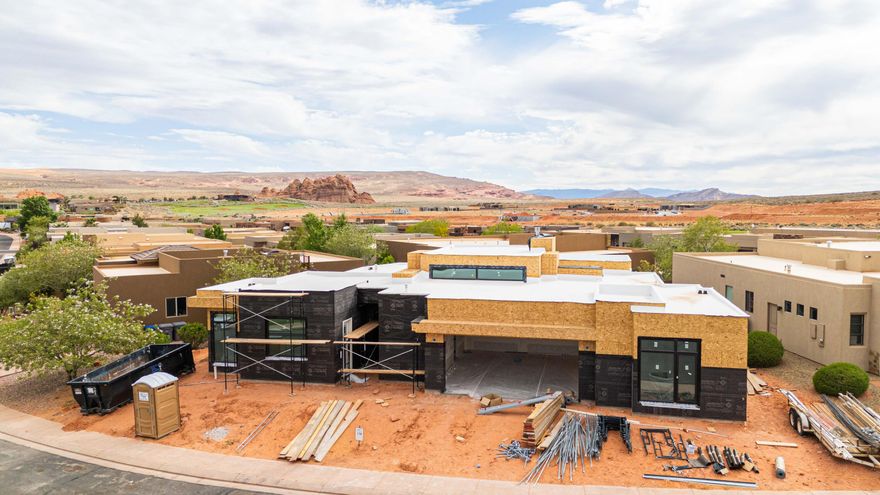 Estimated Completion: July 2026. Experience modern luxury in this stunning 4-bedroom home in The Dunes, featuring a sleek modern exterior, open-concept living spaces filled with natural light, and seamless indoor-outdoor flow to a private backyard with a pool. The spacious primary suite offers a spa-inspired bath with a freestanding soaking tub, while three additional bedrooms provide flexibility for family or guests. An attached casita with its own private entrance is perfect for visitors. Secure the home early and you'll have the opportunity to meet with the designer and personalize your finishes. Enjoy the added privacy, beautifully maintained surroundings, and elevated lifestyle that come with golf course living all in one of the area's most desirable communities. Residents enjoy access to the exclusive Sand Hollow Clubhouse and championship golf course, with discounted golf privileges, along with The Grille restaurant, seasonal pools, a fitness center, and nearby shopping. The HOA covers landscaping, maintenance of common areas, and access to the community pool and gym, plus the added peace of mind of hourly security patrol throughout the neighborhood.