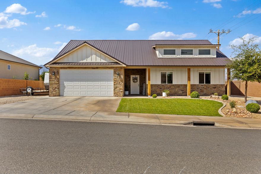 This modern 3 bedroom 2 bath home offers a functional open floor plan with stylish finishes throughout. The primary bedroom offers a walk-in shower and walk-in closet. The kitchen includes a spacious pantry, ample cabinet space and connects seamlessly to the living area. Additionally the laundry room is conveniently located and offers plenty of room. The fully landscaped yard is designed for low maintenance and includes extra parking on the side of the home. The home has great views of the Hurricane mountains, adding to its appeal. An attic above the garage provides convenient additional storage. This home is move-in ready, combining comfort, efficiency, and practical design in a desirable Hurricane location with no HOA!