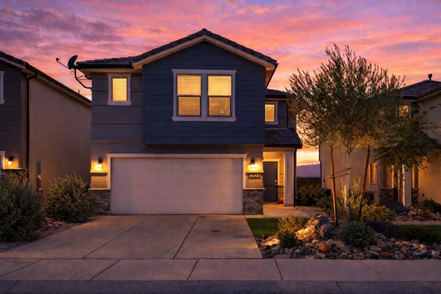 Zelda Drive carries an unmistakably lively energy--neighbors out in the evenings, bikes rolling by, and a sense of life that makes the neighborhood feel instantly welcoming. Out back, you'll enjoy no backyard neighbors, wide-open mountain views, and incredible Southern Utah sunsets right from your own yard. Front and backyard landscaping are maintained by the HOA, giving you more time to enjoy the view and less time on upkeep. Inside, the home has been kept in immaculate condition, featuring luxury vinyl plank flooring, generous storage, and a spacious primary suite with a tiled shower, double vanity, and walk-in closet. Upstairs offers a second gathering space--perfect for a playroom, gaming lounge, or media area--so the main living room downstairs can stay polished and guest-ready. Smart-home features include keypad entry and a Ring doorbell for added convenience and security. BONUS!: Assumable FHA loan with an incredible 2.375% interest rate for qualified buyers. Perfectly positioned near Sand Hollow and Warner Valley recreation, with nearby walking and biking trails and quick access to the new Costco, expanding restaurants, and everyday amenities.