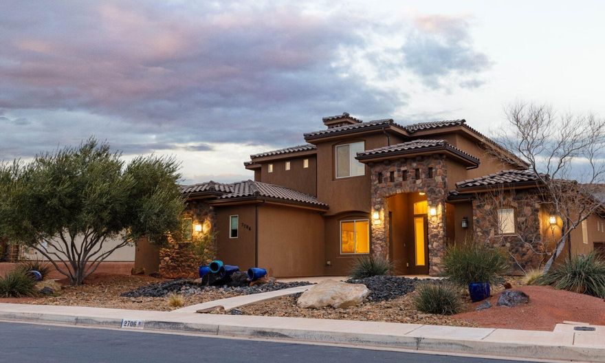 Nestled among stunning red rock hills, this beautifully designed home offers comfort, flexibility, and easy living.
With no HOA and Dixie Power, ownership is budget-friendly. The versatile floor plan includes two spacious gathering
rooms, up to 6 bedrooms (or 5 plus an office), and a main-level guest suite with en-suite bath—ideal for guests or
multi-generational living. The gourmet kitchen features attractive upgrades and opens to an inviting living area anchored
by a cozy fireplace, perfect for everyday living and entertaining. Enjoy low-maintenance xeriscape landscaping, a
tranquil water feature, and a large covered patio. Conveniently located near parks, pickleball courts, and outdoor recreation. Owner/Agent.