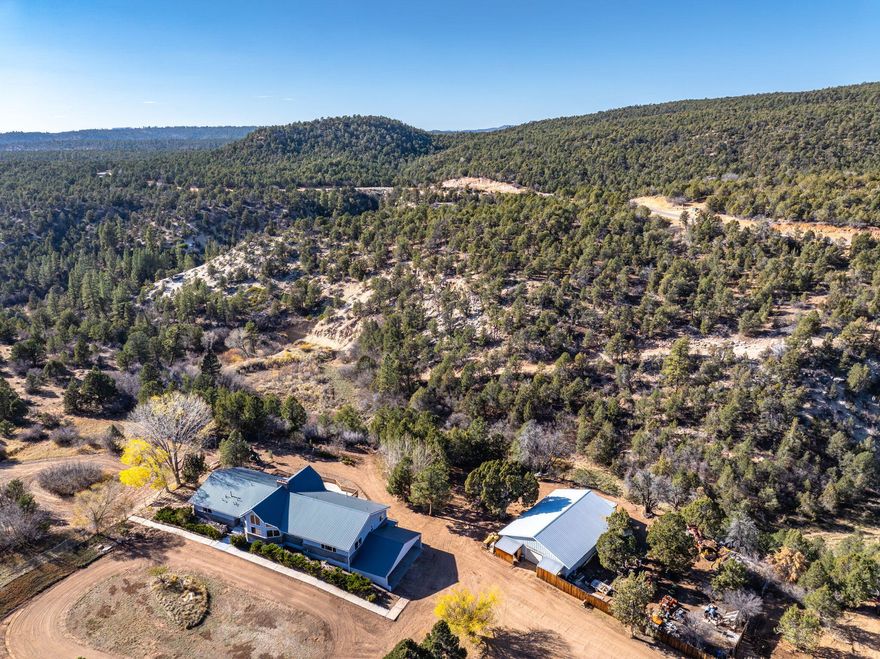 Rare multi-parcel opportunity located on paved North Fork Road, just five miles east of Zion National Park. This exceptional property includes 4 parcels totaling 143+ acres of scenic Southern Utah terrain, highlighted by a private canyon with a natural spring - providing privacy, water, and elevated views throughout the property. The primary 80.2-acre parcel features a 5,343 SF home built in 1990 with 6 bedrooms, 4 bathrooms, a fully finished lower level with second kitchen, large covered patio, expansive deck, garages, and covered parking. Additional improvements include a 2,100 sq/ft detached shop and a 1,368 sq/ft secondary residence. The property includes valuable water assets: 7.40 acre-feet of domestic and irrigation water rights, 12.2 acre-feet of approved pond storage with fish