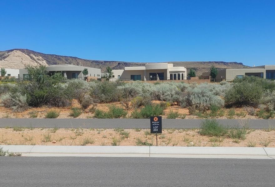 Large custom home lot in the scenic Ledges of Saint George Golf community. Great views of Snow Canyon State Park and Fishrock. Nearby public park including pickleball. Bring your own builder!