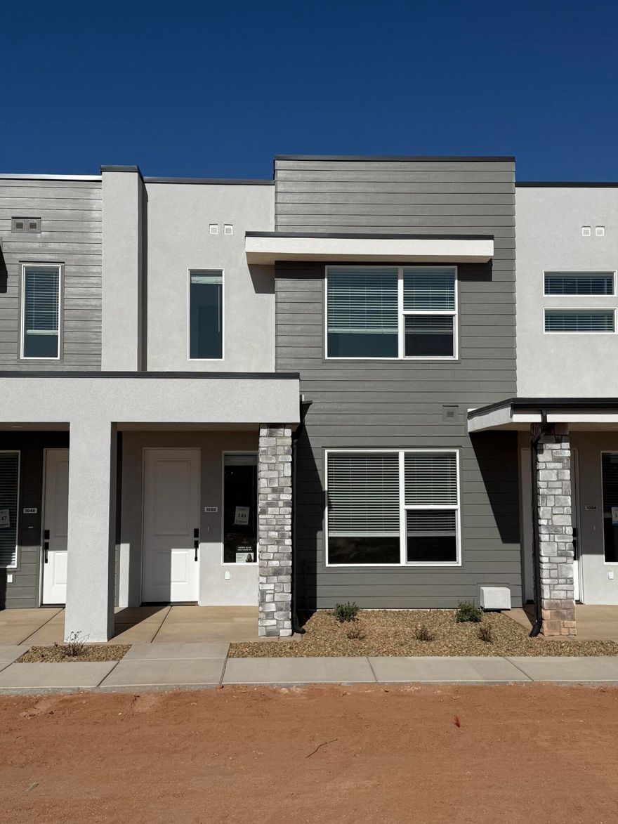 This inviting 3-bedroom, 2.5-bathroom townhome boasts a prime location just moments away from Zion Shores surf park, Warner Valley, and Sand Hollow making it perfect for outdoor enthusiasts and adventure seekers. The spacious living area flows seamlessly into a well-appointed kitchen complete with stainless steel appliances. The generous primary bedroom is complete with an en-suite and walk in closet. Two additional bedrooms provide plenty of space for guests, a home office, or hobbies and they share a stylishly designed full bathroom. A convenient half-bath is located on the main level. Step outside to enjoy your own covered patio where you can enjoy views of Warner Valley and Pine Valley.