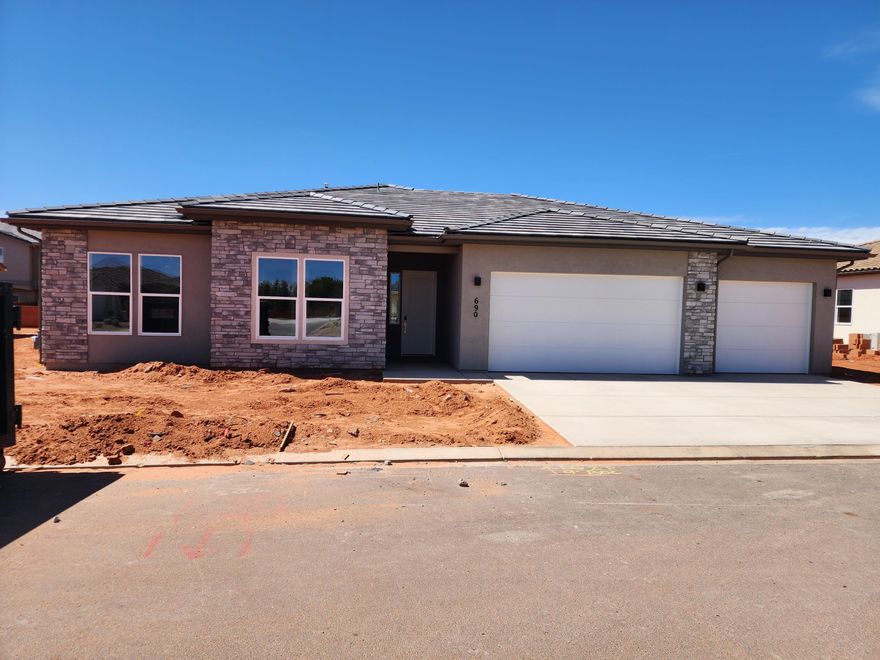 Interest Rates as low as 3.99% available through our preferred lender. Surrounded by beautiful desert and red rock scenery. Fire Lake at Ivins Reservoir, Unity Park, and Kayenta Art Village are very close by. A short drive away are Tuacahn Ampitheater, Snow Canyon State Park and Black Desert Golf Course and resort. This floorplan has a sunroom extension off the large kitchen. Enjoy a gourmet kitchen, quartz countertops throughout, a fireplace in the great room, and a shady covered patio. The 3rd car garage bay is double deep so there is room for all the cars and toys.