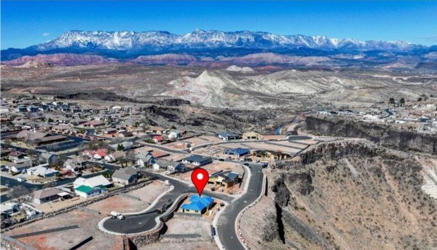 **DO NOT MAKE YOUR HOME PURCHASE WITHOUT SEEING THIS ONE IN PERSON** You won't find another home with a massive four car garage and stunning views that will NEVER be obstructed.

Nestled along the breathtaking ridges of the Virgin River, this exquisite Madsen Homes, custom residence was designed to capture the stunning panoramas of Hurricane Valley. Located in the beautiful Falcon Ridge community, this home is truly a must-see.

Expansive windows and 8' sliding doors fill the home with natural light, offering breathtaking views from the Owner's Suite, Living Room, an additional bedroom, and the charming front courtyard off the Owner's Suite. The spacious great room and kitchen are ideal for both everyday living and entertaining, featuring Frigidaire Professional Stainless Appliances, including 33'' Single-Door, side by side Refrigerator and Freezer,elegant quartz countertops, and knotty alder cabinetry throughout. Elegant gold and black fixtures add the perfect final touch. Step outside to a fully landscaped backyard with a covered patio, creating the perfect setting for relaxing evenings and outdoor gatherings. 

Th at 4 Car (Double Tandem) Garage offers plenty of room for your outdoor toys that definitely won't go unused. Falcon Ridge is only 30 minutes from Zion National Park and St. George, and only 15 minutes from Sand Hollow and Quail Creek Reservoirs, several world class golf courses, and unlimited hiking, biking, fishing and boating options. Fire up your UTV and make the quick drive from home to miles of dunes and trails. This property is the perfect blend of tranquility and adventure. It's not just a home - it's a lifestyle.
  
All information believed to be accurate and offered as courtesy only. Buyer to verify all