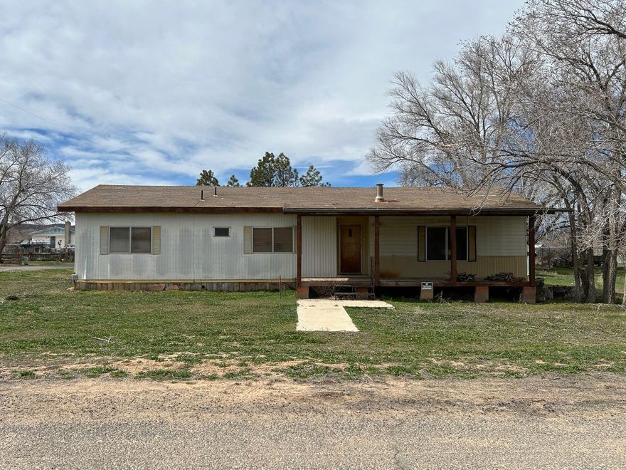 Great starter home or easy recreational getaway in the Heart of the Escalante Grand Staircase Nat'l Monument. Minutes from Mountains, slot canyons and world-class hiking. Turn key with all furnishings & appliances included. Home was updated in the 90's,  large primary bedroom with spacious bathroom and closets. 2 car garage, storage shed & nice front porch with views of the Escalante Canyons!  Comfortable wood stove to keep you cozy in the winter. Covered back deck off the kitchen for country gatherings. Situated on a large corner lot. Needs a little TLC - Perfect opportunity to enjoy the slow pace of life at an affordable price! Ask for details.